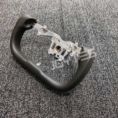 why does tesla have a yoke steering wheel